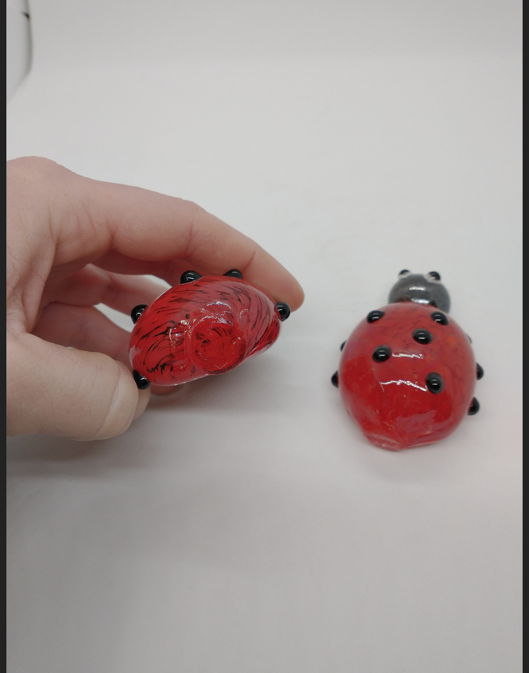 TWO glass lady bugs