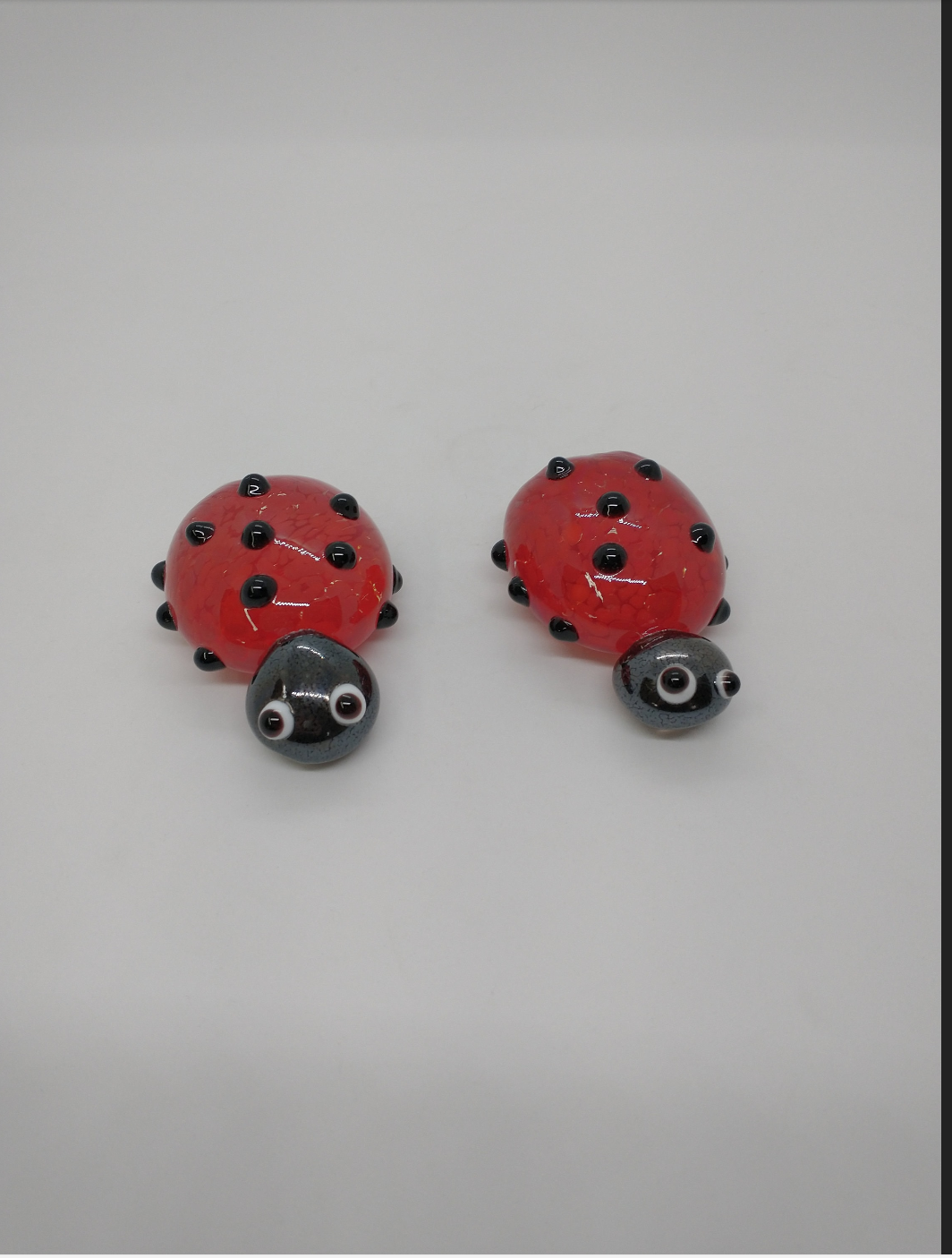 TWO glass lady bugs